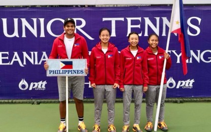 <p><strong>JUNIOR TENNISTERS.</strong> (L-R) Coach Patrick John Tierro, Alexandra Eala, Ma. Carmencita Carlos and Julia Ignacio pose during the opening ceremony of the World Juniors Tennis Championships Asia/Oceania Final Qualifying in Nonthaburi, Thailand on April 2. <em>(Photo courtesy of Michael Francis Eala)</em></p>