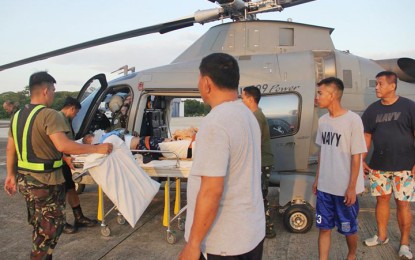 <p>AIR EVACUATION. Naval Forces West personnel assist cargo vessel crewman Santos Tambo Jr., who was air evacuated from the Sulu on April 8, after suffering from a third-degree burn in the face. (Photo courtesy of Western Command PAO) </p>