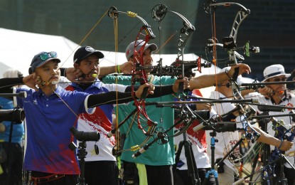 <p><strong>ARCHER'S AIM.</strong> Paul Marton Dela Cruz (second from left) in action during the Asia Cup - Stage 2 archery competition at the Rizal Memorial Baseball field on Saturday (April 7, 2018). Dela Cruz won the Olympic round individual men's compound on Monday (April 9, 2018) for his second gold medal in the world-ranking tournament organized by the World Archery Philippines. <em>(PNA photo by Jess Escaros Jr.)</em></p>