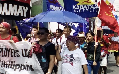<p><strong>RALLYISTS BARRED</strong>. Some of the demonstrators who were barred to go near the venue where President Rodrigo R. Duterte celebrated Labor Day in Cebu City on Tuesday (May 1, 2018). <em>(Photo by Luel Galarpe/PNA) </em></p>