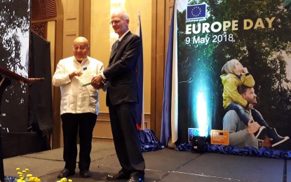 <p>F. Sionil Jose receives the award from Ambassador Franz Jessen at the Europe Day Reception in Makati City. <em>(Photo by Joyce Ann L. Rocamora)</em></p>