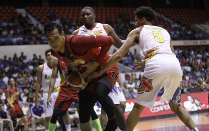 <p>San Miguel Beermen's Junemar Fajardo finds himself double-teamed by Rain Or Shine's Gabe Norwood and Reggie Johnson during the main game of the PBA Commissioner's Cup twin bill at the Ynares Center in Antipolo City on Sunday night (May 13, 2018). <em>(Photo courtesy of PBA Media Bureau)</em></p>