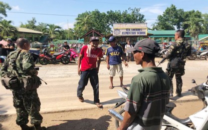 <p><strong>JOINT TASK GROUP WESME BSKE 2018. </strong>Military troops assist in the peace and orderly holding the barangay and youth polls in Puerto Princesa. Photo shows them standing guard outside the Sta. Lourdes Elementary School. <em>(Photo by Wescom Public Affairs Office)</em></p>