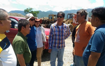 <p><strong>ILLEGAL QUARRY.</strong> Department of Environment and Natural Resources officials serve a cease and desist order to illegal quarry operators of Bolo river in Ilocos Norte on May 16. <em>(Photo by Florante Nicolas)</em></p>