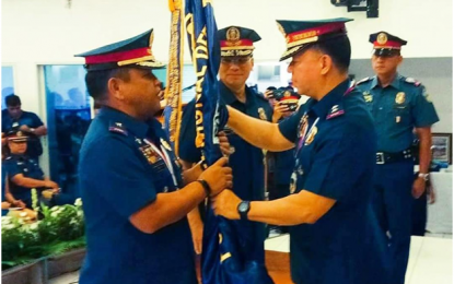 <p><strong>COMMAND TURNOVER.</strong> Police Director Edwin C Roque, Directorate for Plans of the Philippine National Police (PNP) administers the turnover of the Police Regional Office (PRO) Calabarzon command flag to incoming  Chief Supt. Edward E. Carranza (left) from outgoing Chief Supt. Guillermo Eleazar on Saturday (June 2)) at the Multi-Purpose Hall Camp Gen. Vicente Lim, Barangay Mayapa, Calamba City, Laguna. <em>(Photo courtesy of Gil Aman)</em></p>