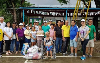 <p>TAM officers and members distribute vitamins, backpacks and school supplies in Barangay Bayotbot day-care center in San Jose, Occidental Mindoro including a wheelchair to 85-year-old Mercedes Olarte.<em> (Photo by TAM)</em></p>