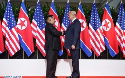 <p>Top leader of the Democratic People's Republic of Korea (DPRK) Kim Jong Un (L) shakes hands with U.S. President Donald Trump in Singapore before the first-ever DPRK-U.S. summit, on June 12, 2018.<em> (Xinhua/The Straits Times)</em></p>