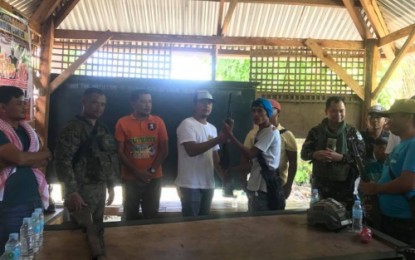 <p><strong>SETTLED.</strong> Lieutenant Colonel Harold Cabunoc (right in fatigue uniform), 33rd IB commander and Lieutenant Colonel Lauro Oliveros, 1st Mechanized IB commander (left in fatigue uniform), help Muslim warring clans end their decades-old “rido” (family feud) in Gen. S.K. Pendatun, Maguindanao. <em><strong>(Photo by 33rd IB)</strong></em></p>
