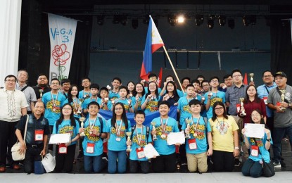<p>WINNERS. Filipino students, together with their coaches, wave the Philippine flag and show the medals and trophies they won at the awarding ceremony of the 2018 Bulgaria International Mathematics Competition (BIMC) in Burgas, Bulgaria <em>(Photo courtesy of MTG) </em></p>