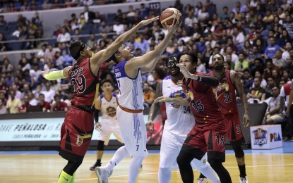 <p>TNT KaTropa's Terrence Romeo drives to the basket against San Miguel Beermen's Arwind Santos during Game 2 of the best-of-three quarterfinal series at the Smart Araneta Coliseum in Quezon City on Wednesday (July 11) night. <em>(Photo courtesy of PBA Media Bureau)</em></p>