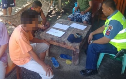 <p><strong>SEIZED</strong>. A police officer conducts further evaluation of the PHP25,000 worth of “shabu” seized from suspected drug courier, Rocman Pua (with blurred face). Pua was arrested at a checkpoint in Datu Piang, Maguindanao on Friday (July 13, 2018). <em>(Photo by 6ID)</em></p>