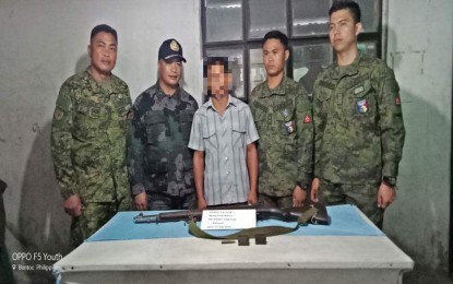 <p><strong>NPA SURRENDER.</strong> Members of the 503rd Brigade of the Philippine Army receive a Garand Rifle from Alias “Sibat” (center), a 37-year-old NPA leader for two decades at the boundaries of Abra, Mountain Province, and Ilocos Sur, who surrendered to government troops in Mountain Province on Monday (July 16, 2018). <em>(Photo courtesy of 5ID)</em></p>