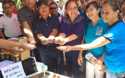 <p><strong>NFA RICE.</strong> Department of Agriculture (DA) Secretary Emmanuel Piñol (3rd from left) and DA-12 Director Mila Casis (3rd from right) show NFA rice available to consumers at Php27 per kilo. <em><strong>(Photo from NFA-North Cotabato)</strong></em></p>