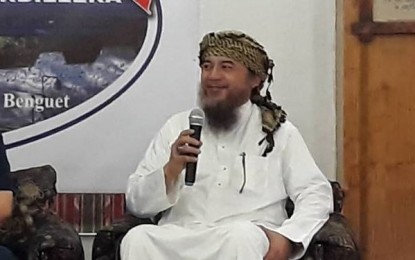 <p><strong>MUSLIM COMMUNITY SUPPORT.</strong> Muslim leader, Imam Bedijim Abdulla,  explains the participation of the Muslim community in keeping the peace and order in the Cordillera region. Abdulla, vice chairman of the multisectoral Regional Advisory Council for the Police Regional Office in Cordillera, was guest speaker at the celebration of the Police Community Relations Month held in Camp Bado Dangwa in Benguet province on Tuesday (July 176, 2018). <em>(Photo by Pamela Mariz Geminiano)</em></p>
