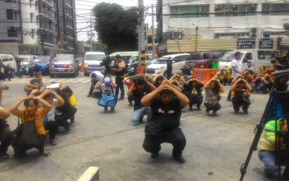 <p>Employees of the Metropolitan Manila Development Authority (MMDA) do the 'duck, cover and hold' during the Metro Manila Shake Drill held Thursday (July 19, 2018). </p>