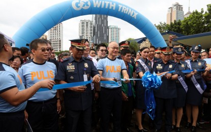 <p>PNP Chief Police Director General Oscar D. Albayalde (4th from left) leads the ceremonial ribbon cutting for the opening of booths at the "People's Day sa Kampo Crame" during the 23rd Police Community Relations Month Celebration held at Camp Crame in Quezon City on Saturday (July 21, 2018). <em>(PNA photo by Joey O. Razon)</em></p>