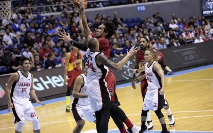 <p>SMB EARNS FINALS SEAT. San Miguel Beermen's Junemar Fajardo drives to the basket amid tight defense from four Alaska Aces players during the Game 4 of their best-of-five semifinal series at the Smart Araneta Coliseum in Quezon City on July 22. The Beermen won, 104-99, and earned the first seat in the PBA Commissioner's Cup Finals. <em>(Photo courtesy of PBA Media Bureau)</em></p>