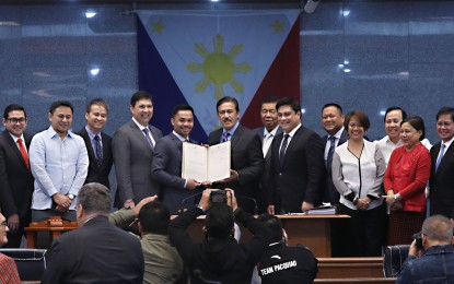 <p>CONGRATS, MANNY! Senate President Vicente "Tito" Sotto III, along with fellow senators, hands over Senate Resolution 788 congratulating boxing icon Senator Emmanuel "Manny" Pacquiao for winning against Argentinian boxer Lucas Matthysse, at the Session Hall of the Senate in Pasay City on Tuesday (July 24, 2018). <em>(PNA photo by Avito C. Dalan)</em></p>