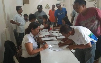 <p><strong>SEPARATION PAY.</strong> Workers of the Meralco Industrial Engineering Services Corporation (Miescor) line up to receive their separation pay from their employer, facilitated by Ms. Ching B. Banania, Single Entry Approach Desk Officer (SEADO) of the Department of Labor and Employment (DOLE)  Albay Provincial Field Office, July 23, 2018.  <em>(Photo courtesy of DOLE-Albay)</em></p>