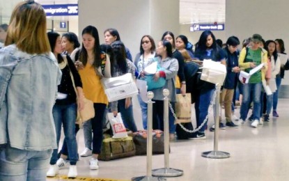 <p>BACK HOME. Returning overseas Filipino workers from the United Arab Emirates await their turn at the immigration gate upon their arrival at the Ninoy Aquino International Airport on July 25, 2018. <em>(Photo courtesy of DFA-OPD)</em></p>