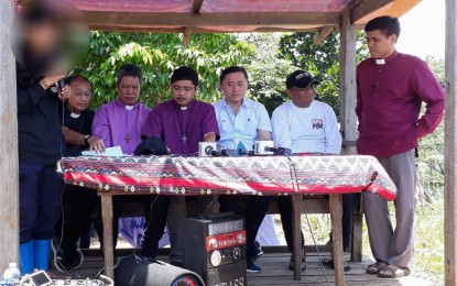 <p>Special Assistant to the President Secretary Christopher Lawrence "Bong" Go (3rd from right) with members of the Exodus Movement for Justice and Peace and Police Insp Menard Cui (2nd from right) listens as Ka Tricia reads the release order.<em><strong>Lilian C. Mellejor</strong></em></p>