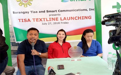 <p><strong>TEXTLINE LAUNCHING.</strong> The first barangay-based infocast in the country was launched in Barangay Tisa, Cebu City on Friday (July 27, 2018). The 'Tisa Textline' launching was spearheaded by (from left) Tisa barangay captain Philip Zafra and Smart Communications' Community Development Partnerships head Nancy Nacua, and Smart Area Development chief Lalaine Musain. (<em>Photo by Bebie Jane Casipong/PNA</em>) </p>