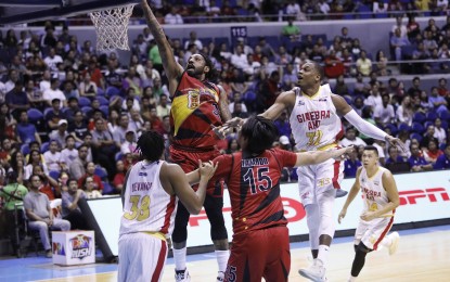 <p>San Miguel Beermen's Renaldo Balkman escapes the defense of Ginebra Kings' Justin Brownlee and drives to the basket at Game 2 of the PBA Commissioner's Cup Finals best-of-seven series at the Smart Araneta Coliseum in Quezon City on July 29, 2018. The Beermen whipped Barangay Ginebra, 134-109. <em>(Photo courtesy of PBA Media Bureau)</em></p>