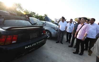 <p><strong>'HOT' CARS DESTROYED. </strong>President Rodrigo Roa Duterte leads the inspection of contraband luxury vehicles before they were subjected to condemnation and public destruction at Port Irene in Sta. Ana, Cagayan on July 30, 2018. A total of 68 contraband luxury vehicles worth over PHP277 million and eight contraband luxury motorbikes worth over PHP19 million were destroyed as part of the President's campaign against smuggling and corruption in the government. Joining the President are Bureau of Customs Commissioner Isidro Lapeña, Cagayan Special Economic Zone (CEZA) Administrator and CEO Raul Lambino, and Sec. Bong Go of the Office of the Special Assistant to the President. <em>(Robinson Niñal/Presidential Photo)</em></p>
