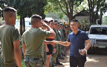 <p><strong>METROBANK FOUNDATION'S 10 OUTSTANDING FILIPINO AWARDEE:</strong> File photo shows the awardee, Lt. Colonel Danilo Facundo (in blue polo shirt), shaking the hand of a soldier and being saluted before he left as commander of the Marine Battalion Landing Team-4 in southern Palawan early this year. <em>(Photo courtesy of MBLT 4)</em></p>