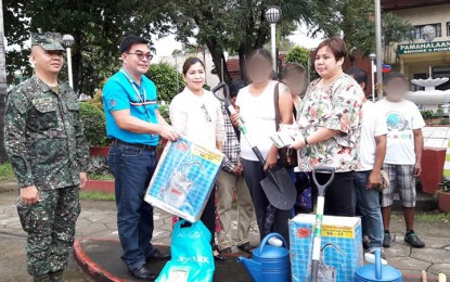 <p><strong>HELPING FORMER REBELS IN PALAWAN:</strong> (From left) Lt. Col. Darwin de Luna, commanding officer of Marine Battalion Landing Team 4; Renato Pantaleon, provincial director of TESDA in Palawan, Mayor Mary Jean Feliciano of Brooke’s Point; a former rebel dependent; and Abigail Ablaña, chief of the Palawan Provincial Social Welfare and Development Office (PSWDO), during the distribution of garden tools and starter seedlings on August 6 in Brooke’s Point town.<em> (Photo contributed by Romeo Tan)</em></p>