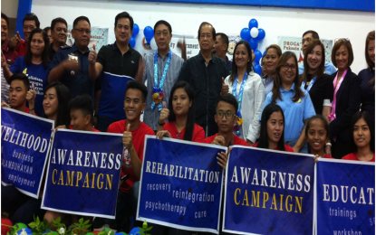 <p><strong>COMMITMENT TO FIGHT DRUGS. </strong>Dangerous Drugs Board Chairman Secretary Catalino S. Cuy (standing 4th from left) flashes the thumbs up sign together with Calabarzon Police Regional Director Chief Supt. Edward Carranza (2nd from left), Columba City Mayor Justin Marc SB Chipeco (3rd left); Laguna 2nd District Rep. Joaquin M. Chipeco Jr. (on Sec. Cuy’s left); Dr. Raquel P. Tolentino, in-country coordinator of Community Anti-Drug Coalition in America (CADCA) and AADAC Philippines Chair, city officials and the officers (holding the banners) of the youth movement against illegal drugs. Secretary Cuy was guest of honor and keynote speaker at the Community Anti-Drug Coalition of Calamba City (CADCC) first Anniversary Celebration and Oath-taking of officers and members of the Kabataang Ayaw sa Droga sa Columba City (KADCC) at the LLC Auditorium, Calamba Elementary School on Saturday (Aug. 11, 2018). <strong><em>(Photo by Saul E. Pa-a) </em></strong></p>