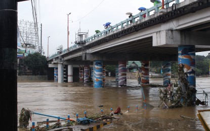 <p><strong>SWOLLEN RIVER.</strong> During heavy downpour, the Marikina River overflows, causing flooding in its surrounding areas. <em>(PNA file photo)</em></p>