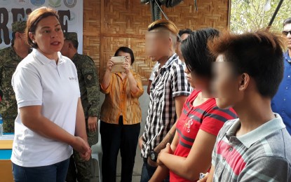<p>Davao City Mayor Sara Duterte talks to three of the eight former New People' Army rebels who surrendered to the government. The surrenderees were presented to the mayor in a press conference at the 16th Infantry Battalion headquarters in Barangay Dalisay, Panabo City on Monday. <em>(Photo by Lilian Mellejor/PNA)</em></p>