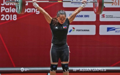<p><strong>FIRST GOLD</strong>. Olympian Hidilyn Diaz topped the women's 53kg event in weightlifing to give the Philippines its first gold medal in the 18th Asian Games in Jakarta, Indonesia on Tuesday. <em>(Photo courtesy of PSC Media Pool)</em></p>