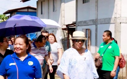 <p><strong>SITE VISIT.</strong> Presidential Communications Operations Office Undersecretary Lorraine Badoy (right) with the chief of the Socilized Housing Finance Corporation (SHFC) Arnulfo Cabling (in striped shirt) visit the Pag-asa Ilang Homeowners Association, Inc resettlement project in Barangay Ilang, Tibungo, Davao City on Tuesday. <em><strong>Photo courtesy of PIA-XI</strong></em></p>
