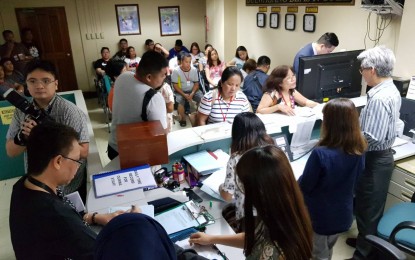 <p>Overseas Filipino workers affected by delayed and cancelled flights due to the runway mishap at the Ninoy Aquino International Airport line up to claim their PHP5,000 cash assistance from the Department of Foreign Affairs. <em>(Photo courtesy of DFA-Office of Public Diplomacy)</em></p>