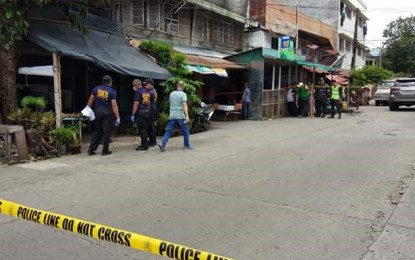 <p>Scene of the crime personnel conducting an investigation in front of the house of slain lawyer Rafael Atotubo. The street in front of the victim’s house was secured by the police. <em>(Photo courtesy of Glazyl Y. Masculino)</em></p>