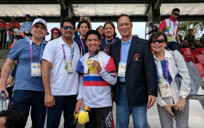 <p><strong>BRONZE MEDALIST.</strong> Daniel Patrick Caluag (center) shows his medal in the 18th Asian Games men's BMX of cycling at the Jakarta International BMX Center. From left are Team Philippines Deputy Chef de Mission Robert Bachmann, Chef de Mission Richard Gomez and former Philippine Olympic Committee president and now Fencing Confederation of Asia president Celso Dayrit.<em> (Photo by Richard Gomez)</em></p>