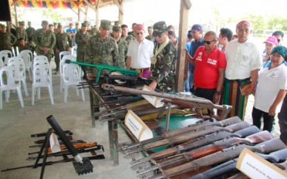 <p><strong>MORE GUNS YIELDED.</strong> The Army’s 6th Infantry Division commander Brigadier General Cirilito Sobejana checks on one of 35 firearms surrendered by the civilians in five Maguindanao towns during a turnover ceremony held at the headquarters of the Army’s 40th Infantry Battalion in Rajah Buayan, Maguindanao. <em><strong>(Photo courtesy of 6ID)</strong></em></p>