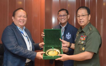 <p><strong>STRENGTHENING PARTNERSHIP. </strong>PCSO Chairman Anselmo Simeon Pinili (left) and PSCO General Manager Alexander Balutan (center) receive a memento from AFP chief General Carlito Galvez Jr. (right) during the latter’s courtesy call at the main office in Mandaluyong City. <em>(Photo courtesy: PCSO Public Information Office)</em></p>