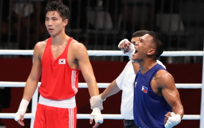 <p>WINNER. Eumir Felix Marcial celebrates his quarterfinal victory over South Korea's Kim Jin-jea in the 18th Asian Games boxing competition at the Jakarta International Exhibition Center in Kemayoran on Wednesday night. <em>(Photo by PSC Media Pool)</em></p>