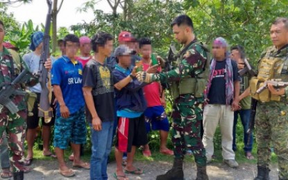 <p>Government troopers accept a surrendered firearm from the New People’s Army members during the turnover ceremonies held Friday (Aug. 31) in Sitio Kisaday, Barangay Kuden, Senator Ninoy Aquino, Sultan Kudarat. A total of 15 NPA rebels yielded to authorities after getting tired of fighting for a futile cause. <em><strong>(Photo by 6ID)</strong></em></p>