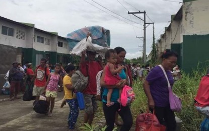 <p>Members of urban poor group Kadamay-Negros leave the government housing site for uniformed personnel in Barangay Felisa, Bacolod City on Friday afternoon, a day after they arrived to demand for houses. <em>(Photo courtesy of  Merlinda A. Pedrosa)</em></p>