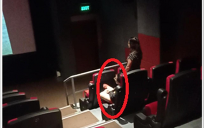 <p><strong>'IMPLAN BANDILA'</strong>. A moviegoer is shown sitting down as the Philippine National Anthem is being played at the City Mall Cinema in Imus City, Cavite on Thursday (September 6, 2018). The moviegoer was later arrested as the Cavite police has been implementing “Implan Bandila”, which targets violators of the country’s “Flag and Heraldic Code”.<em> (Photo courtesy of Imus City PNP)</em></p>