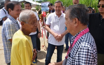 <p><strong>FARM-TO-MARKET ROAD.</strong> Negros Occidental Governor Alfredo Marañon Jr. (right) is greeted by a resident of Barangay Gomez during the inauguration of the P48.443-million farm-to-market road project in Pontevedra town on Friday (September 7, 2018). <em>(Photo by Richard Malihan/Negros Occidental Capitol PIO)</em></p>