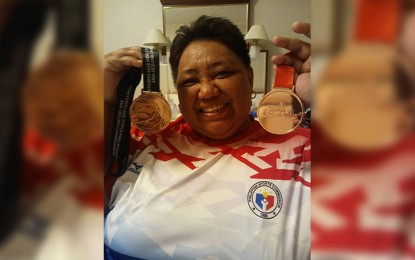 <p><strong>TWIN MEDALS.</strong> Paralympian Adeline Dumapong-Ancheta shows the two bronze medals she won in Japan on Wednesday (September 12, 2018). <em>(Photo courtesy of Irene Soriano-Remo)</em></p>