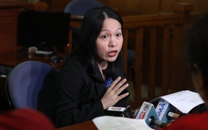 <p><strong>NO ARREST WARRANT YET.</strong> Makati Regional Trial Court (RTC) Branch 148 Clerk of Court, lawyer Mari Rhodora Balabag-Peralta, briefly answers questions from the media after the hearing on the Department Justice's motion for the issuance of a warrant of arrest and hold departure order against Senator Antonio Trillanes IV on Thursday (Sept. 13, 2018). <em>(PNA photo by Joey O. Razon)</em></p>