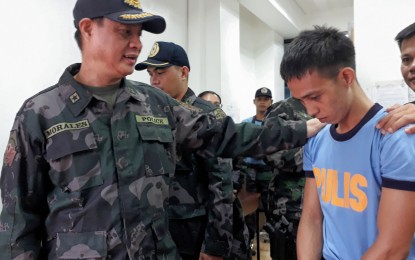 <p>Police Regional Office (PRO)-11 Director Chief Supt Marcelo Morales talks to police trainee PO1 Querubin John Coyno Ferido who was arrested in a buy-bust operation of the Talomo police on Thursday. <em><strong>Photo by Lilian C. Mellejor/PNA</strong></em></p>
