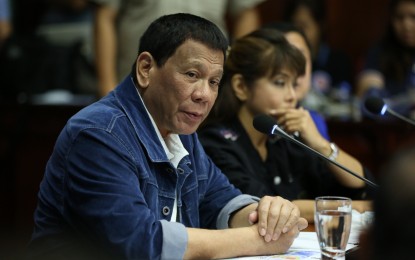 <p><strong>HANDS-ON</strong>. President Rodrigo R. Duterte presides over a situation briefing of areas ravaged by Typhoon "Ompong" in Laoag City, Ilocos Norte on September 16, 2018. <em>(Presidential Photo) </em></p>