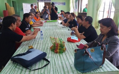 <p><strong>COORDINATION.</strong> Officials from various government agencies sit down to coordinate ongoing landslide rescue operations in Itogon, Benguet on Tuesday. The coordination meeting was initiated by Presidential Communications Operations Office (PCOO) Undersecretary Lorraine Marie Badoy and Assistant Secretary Marie Rafael, who visited the site to see how the department could help. Itogon Mayor Victorio Palangdan also attended the meeting. <em>(Photo by Liza T. Agoot)</em></p>